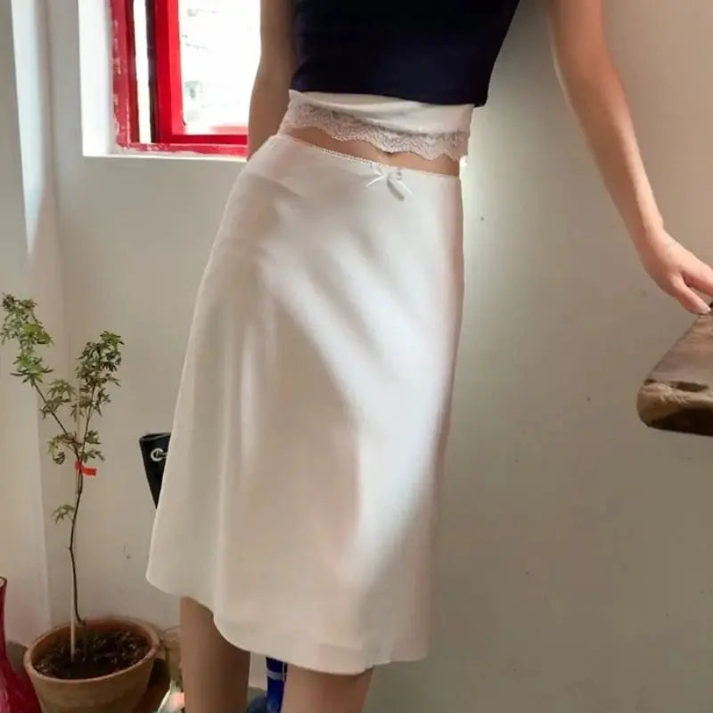 White satin A-line midi skirt with a small front bow