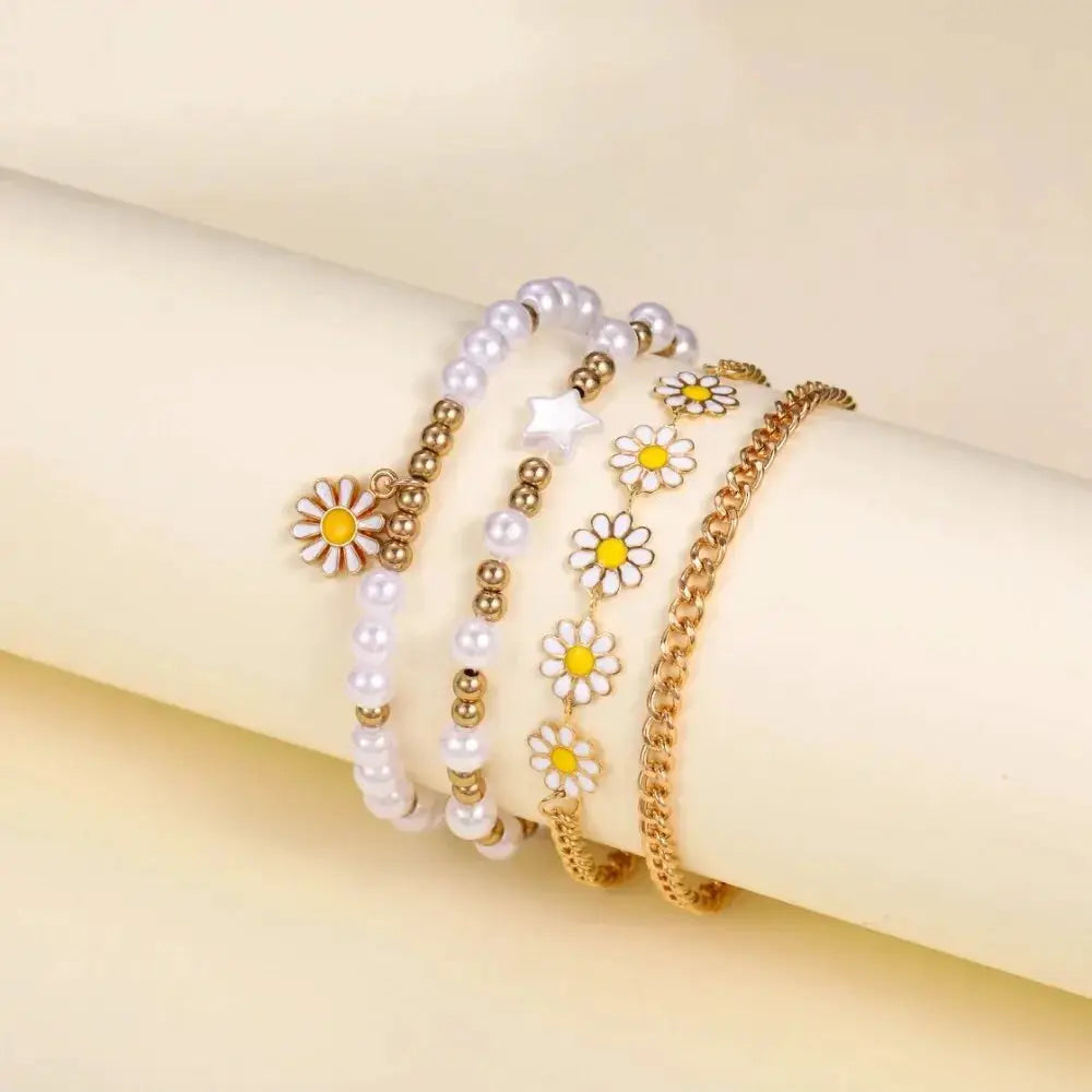5-piece girls bracelet set with pearl bead strands, white daisies with yellow centers, star charm, and gold-tone chains