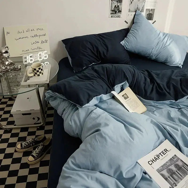 Duvet set, solid color double-washed cotton, 4-piece in light blue and navy on bed
