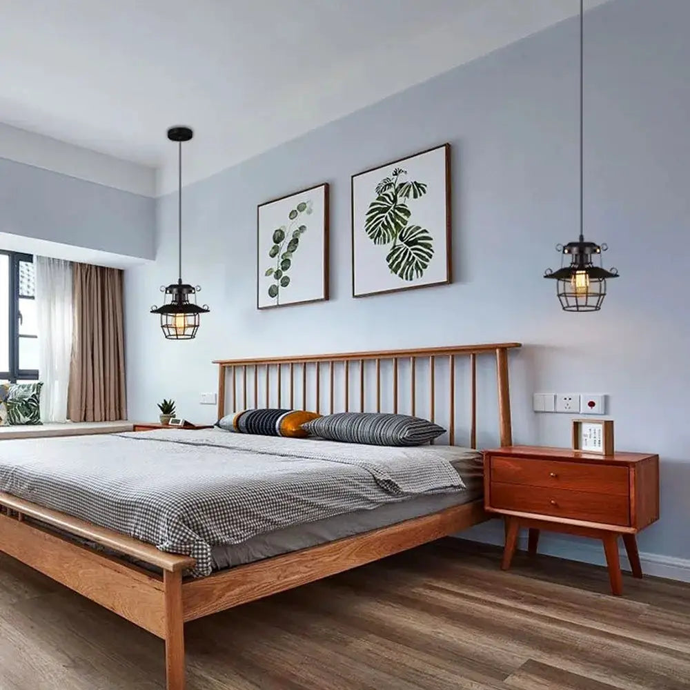 Simples Market industrial pendant lights, two black metal cage bulbs over a wooden bedroom bed
