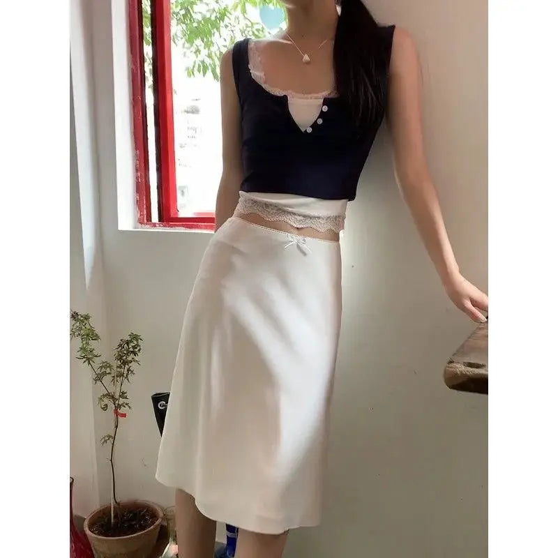 White satin A-line midi skirt with a delicate bow at the waist
