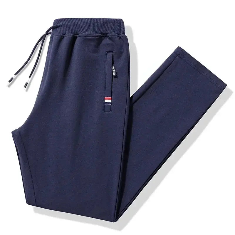 Men's navy blue cotton track pants with elastic waistband and zip pocket