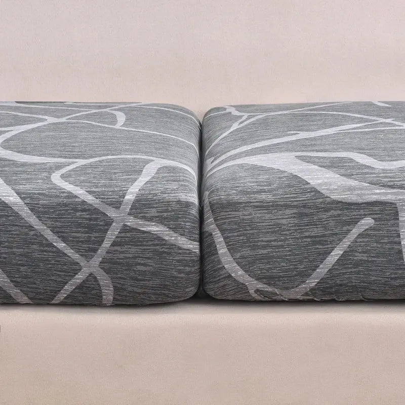 Stretch cushion slipcovers for two gray cushions with white abstract lines; Simples Market anti-slip protectors