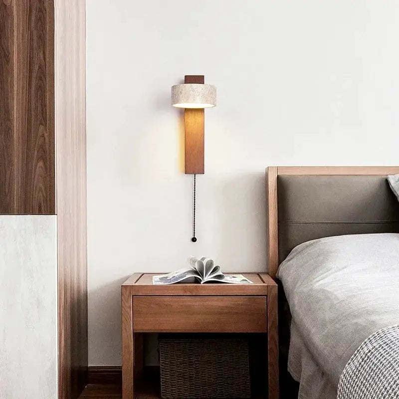 Cream-style bedside wall lamp with walnut finish, pull-chain switch, rotatable LED light above a nightstand.