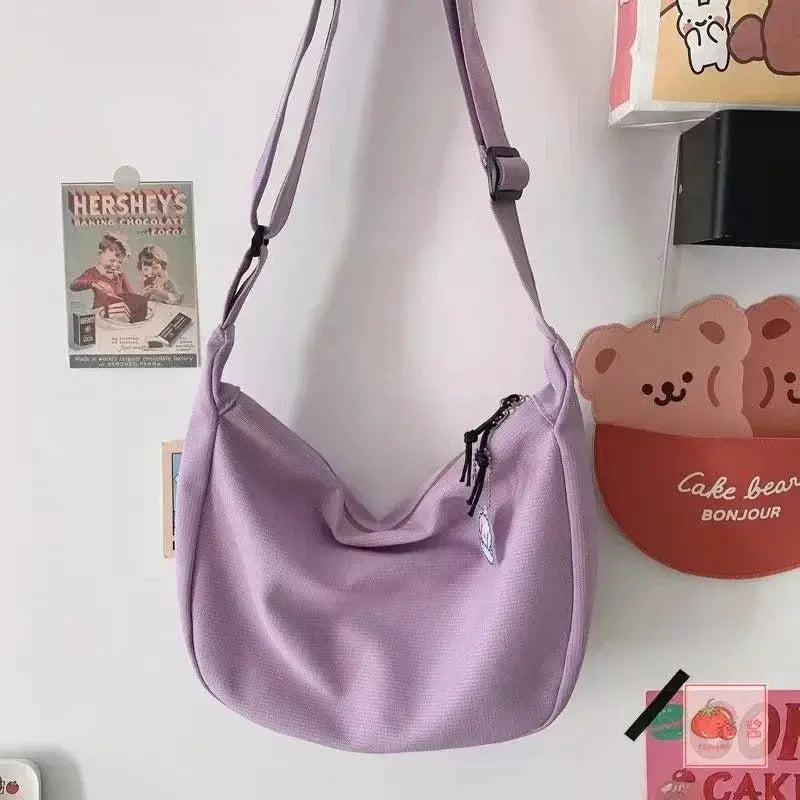 Shoulder bag for women in lavender purple with adjustable crossbody strap and large-capacity design.