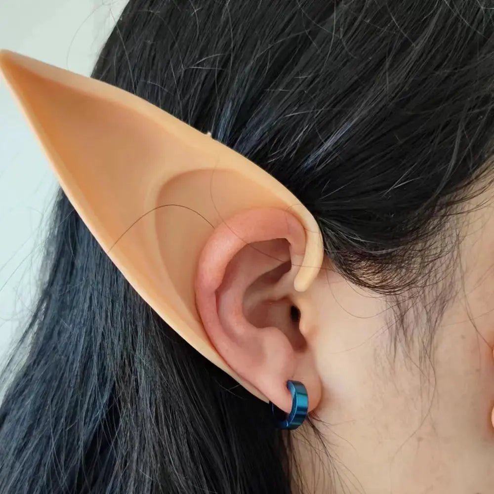 Link cosplay elf-ear prosthetic with blue hoop earring on black hair