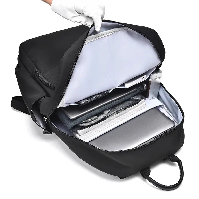 Laptop backpack by Simples Market, black, large-capacity unisex school bag opened to reveal laptop, tablet, and notebook.