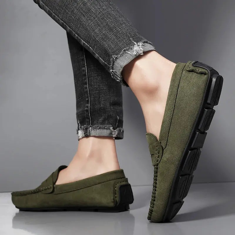Men's olive-green suede loafers with slip-on design and chunky black outsole (two shown)