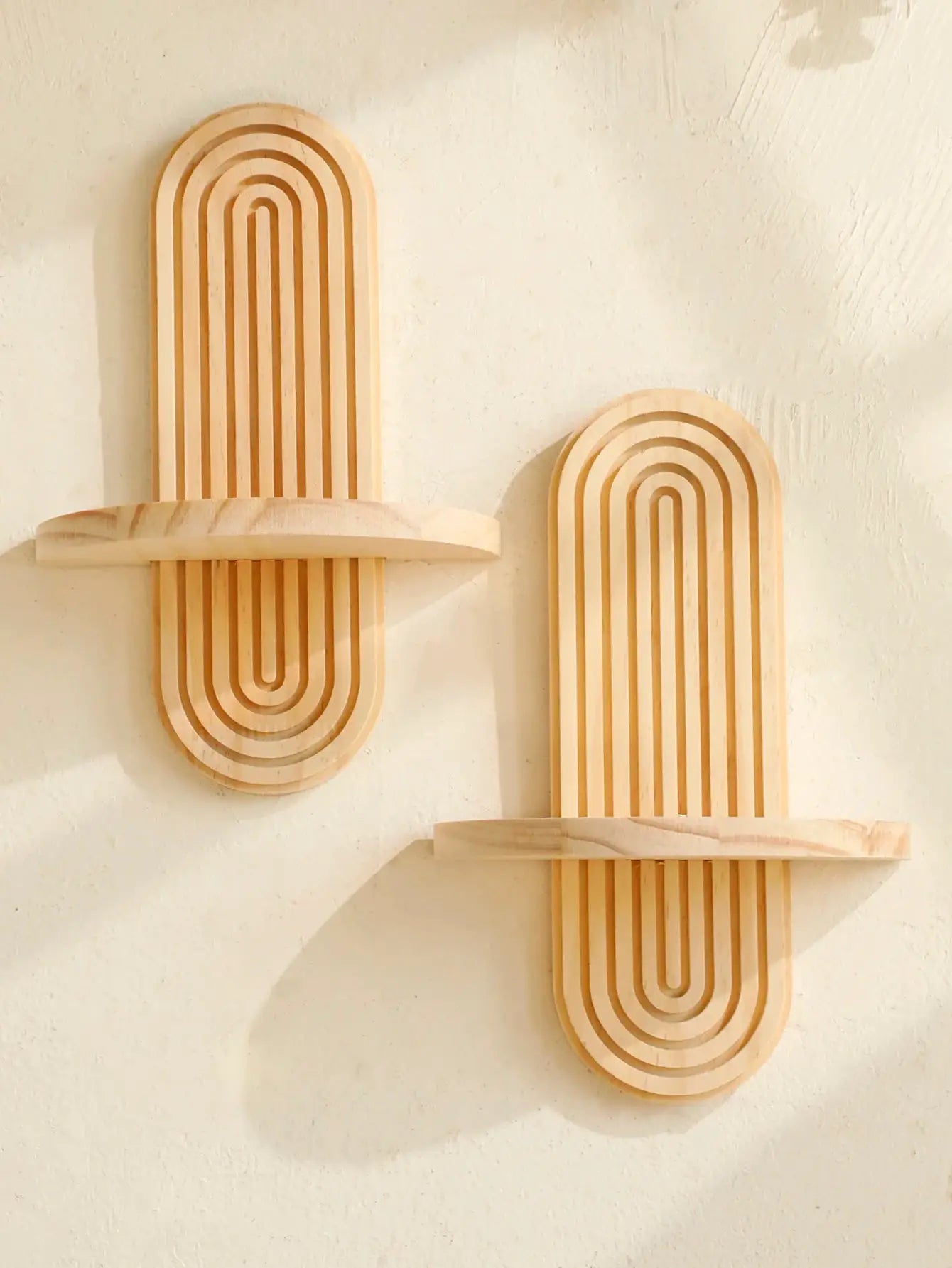 2 geometric boho-style wooden wall shelves with nested arch frames in natural finish