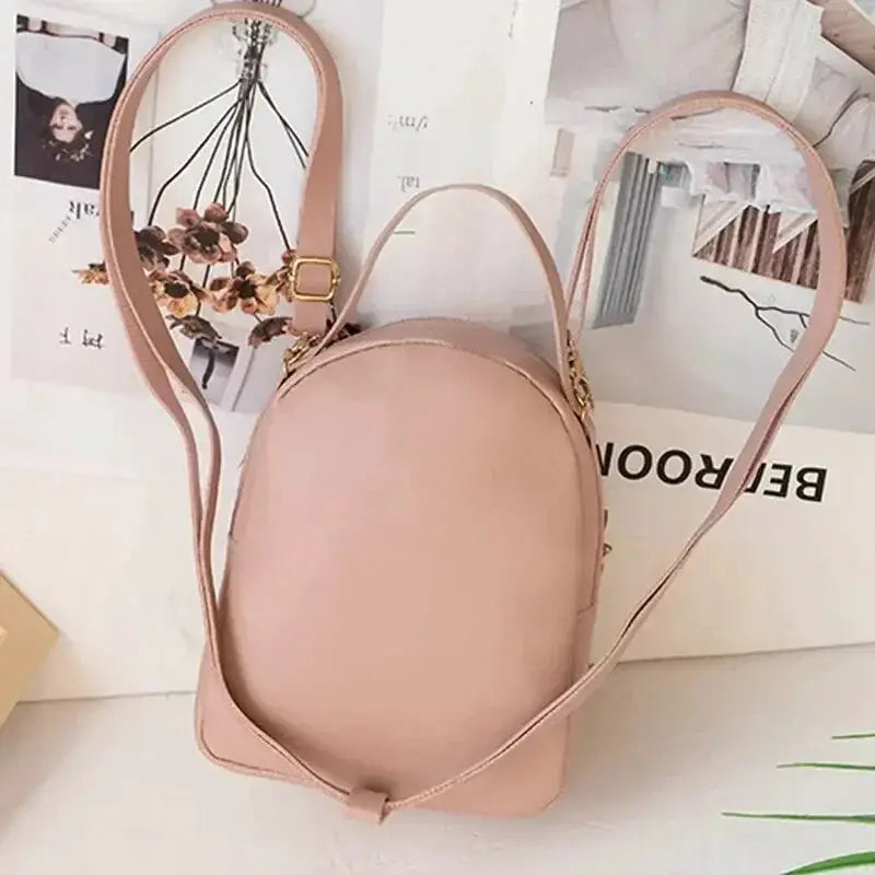 Mini backpack in blush pink with rounded silhouette and adjustable straps