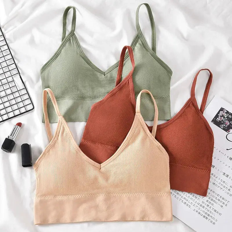 Kit of 4 women's seamless bras set in green, peach, nude, and rust; ribbed stretch padded bralettes