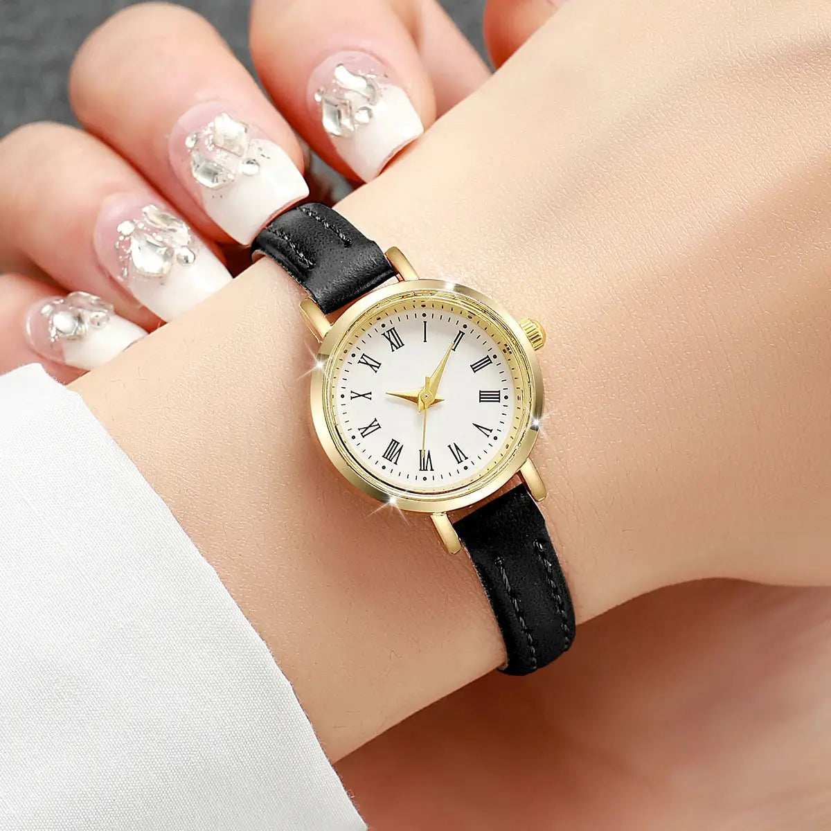 Women's fashion watch with gold-tone case, white Roman-numeral dial and black leather strap