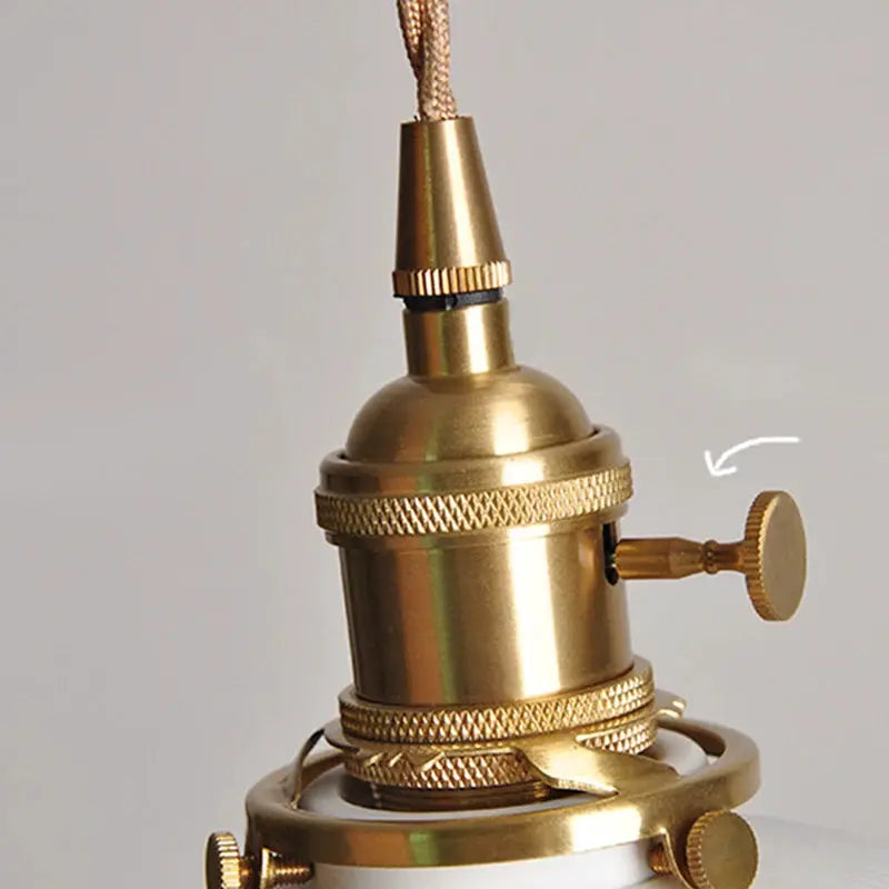 Bronze vintage pendant light with knurled adjustment knob, brass hardware, and braided cord (close-up view)