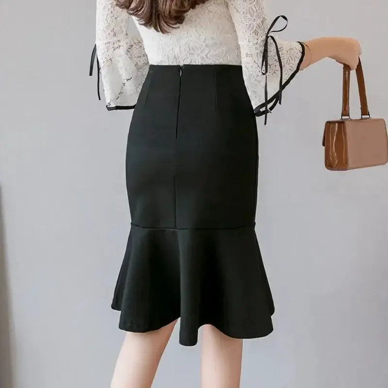 Black high-waisted pencil skirt with a flared, ruffled hem.