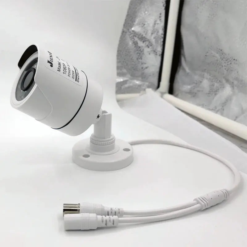 JIENUO CCTV security camera on white mount with white cables
