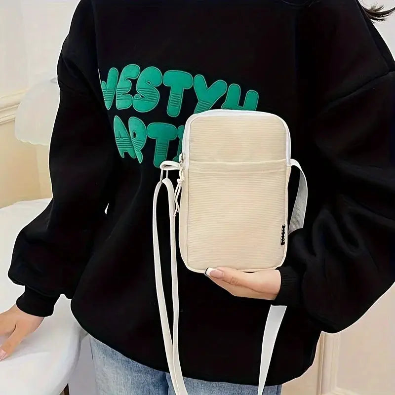 Simples Market beige canvas vertical crossbody bag with front zip pocket and white strap