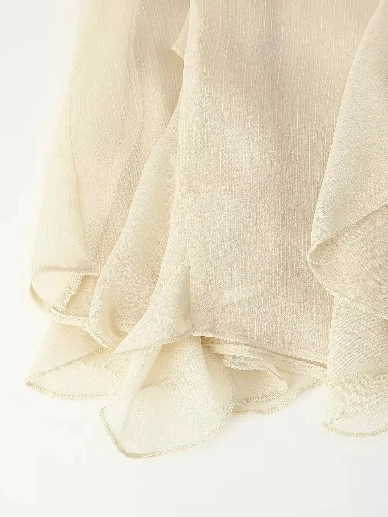 YENKYE women's semi-sheer cream blouse with ruffle trim and layered hem