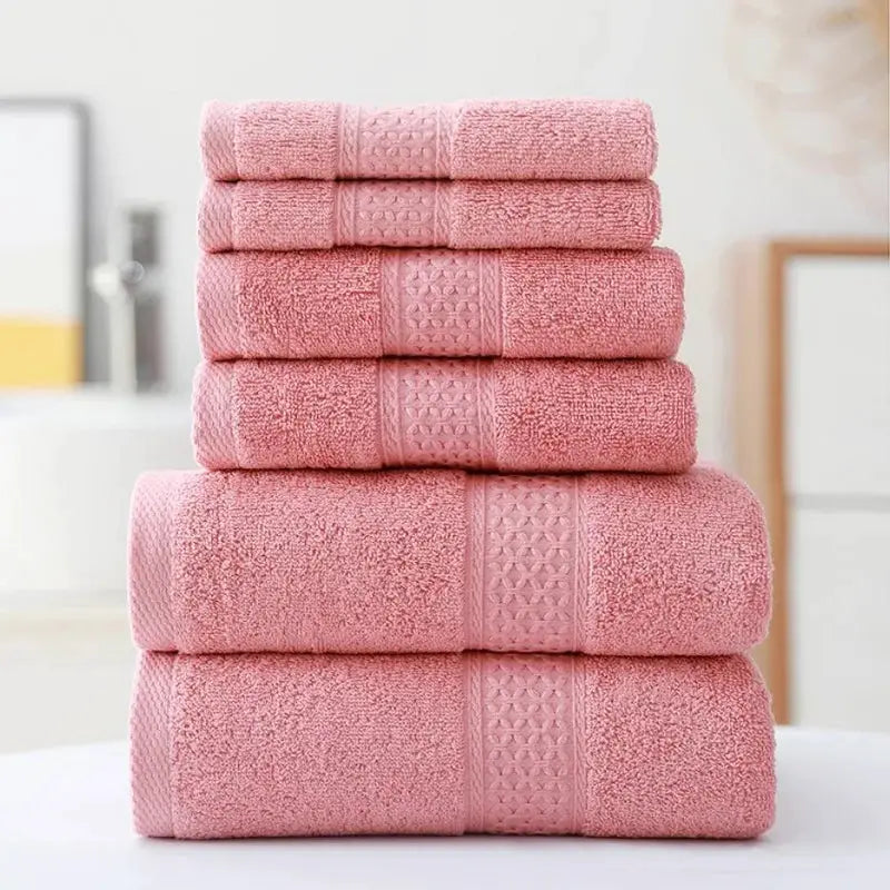 3-piece pink cotton towel set including bath towel, hand towel, washcloth; ultra-soft and highly absorbent.