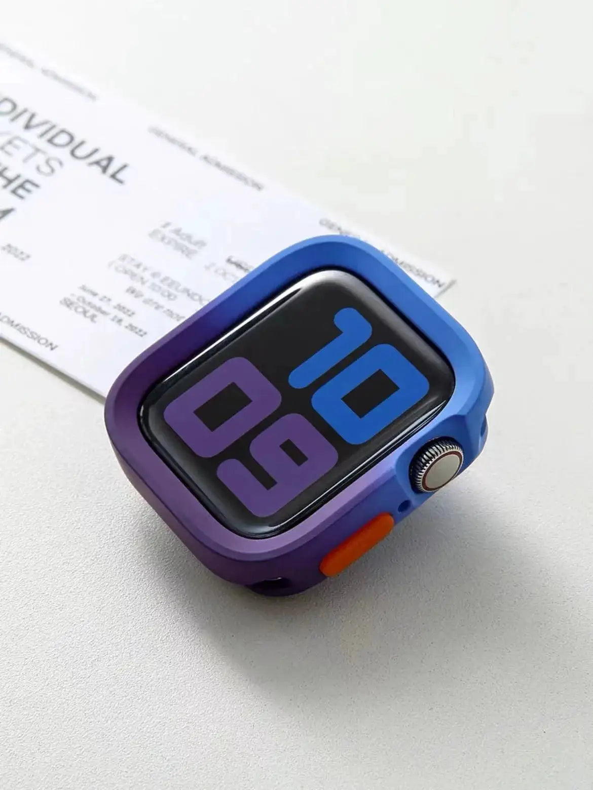 Apple Watch bumper silicone case by Simples Market for 40–49mm watches, blue–purple gradient with orange side button.