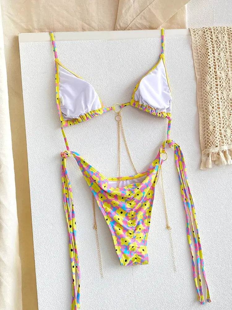 Simples Market two-piece triangle bikini set with white cups, yellow trim, floral micro thong bottom