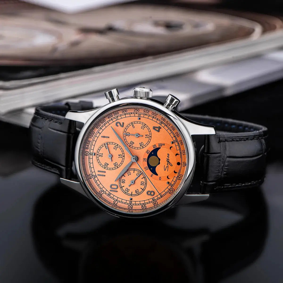 Sugess men's chronograph wristwatch with orange dial, moonphase, stainless steel case, black leather strap