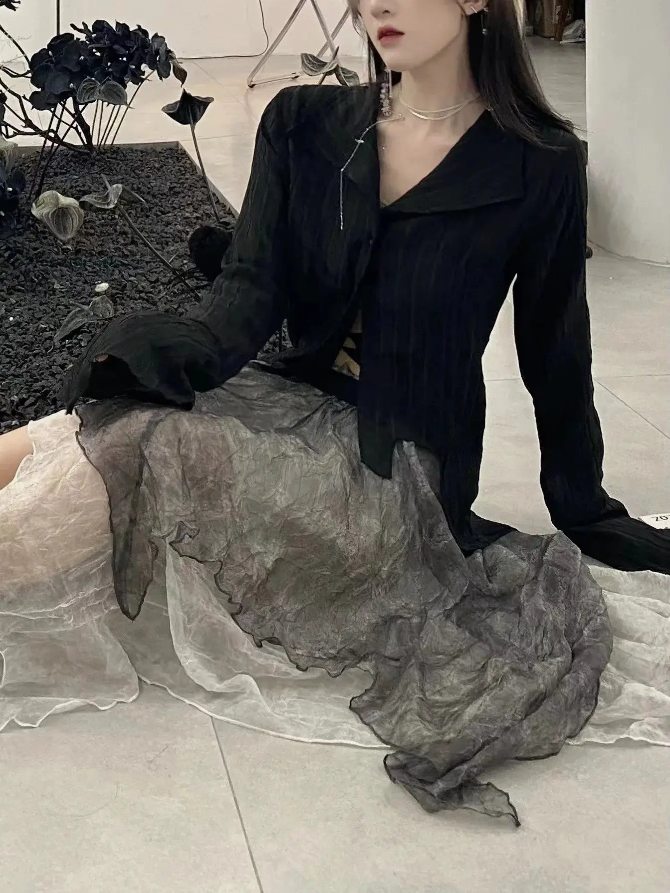Karrram Gothic black blouse with long sleeves and oversized irregular collar, paired with a gray crinkled skirt