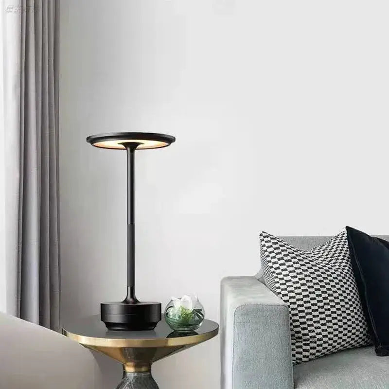 Wireless simple decorative table lamp by Simples Market; black metal, circular top, touch-dimmable, rechargeable.