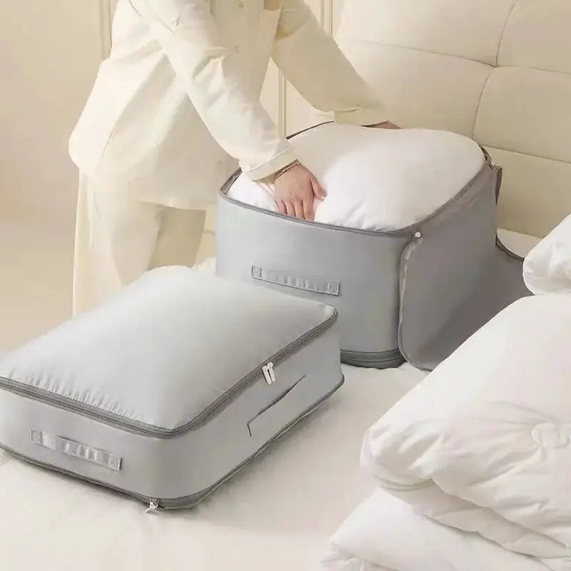 Two gray Simples Market heavy-duty self-compressing storage bags with handles and zippers for clothes and blankets