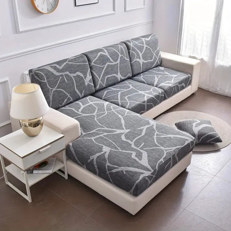Simples Market elastic floral-printed sofa seat cushion cover for L-shaped couch, gray with white branch pattern.