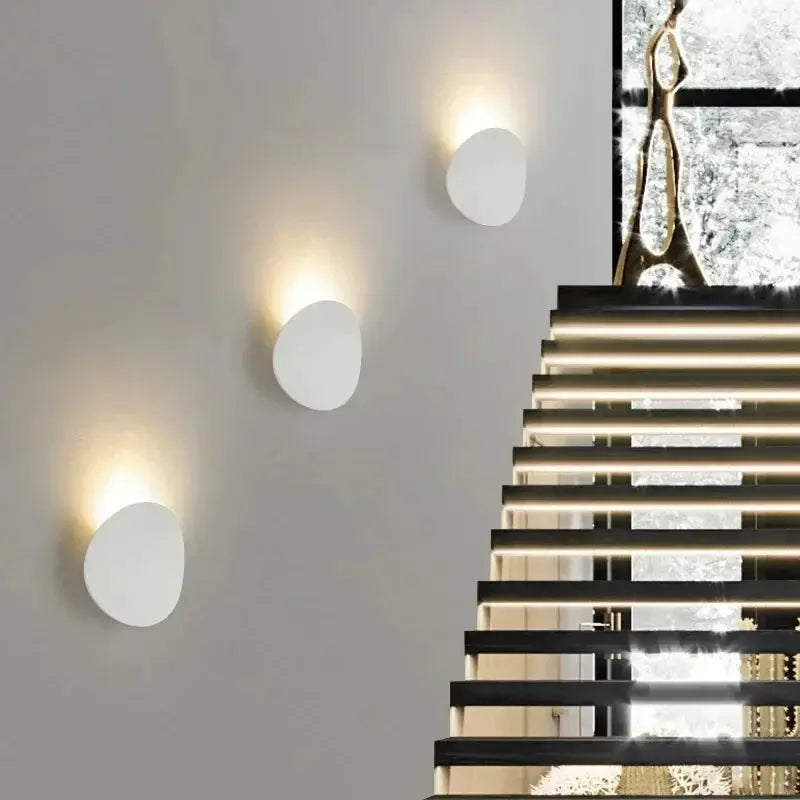 4 white circular outdoor LED wall lamps with warm glow, wall-mounted along a staircase.