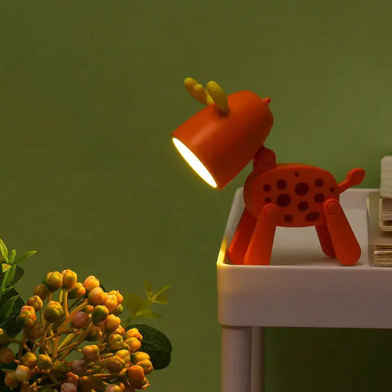 LED mini night light desk lamp in orange deer design with foldable legs on white table