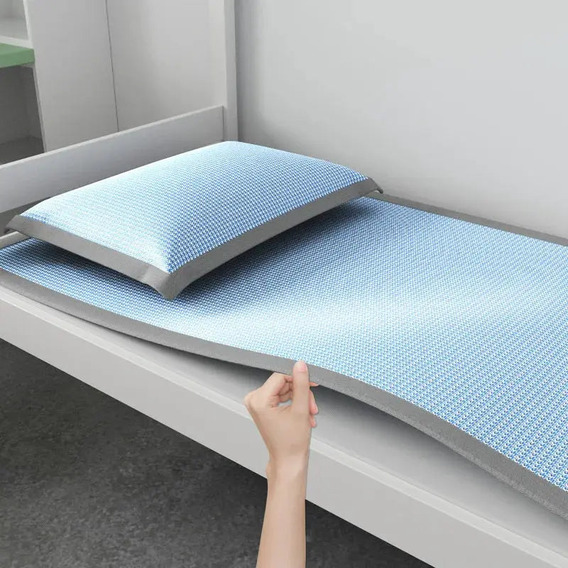 Ice silk sleeping mat with blue jacquard breathable cover and matching pillow on dorm bed Simples Market