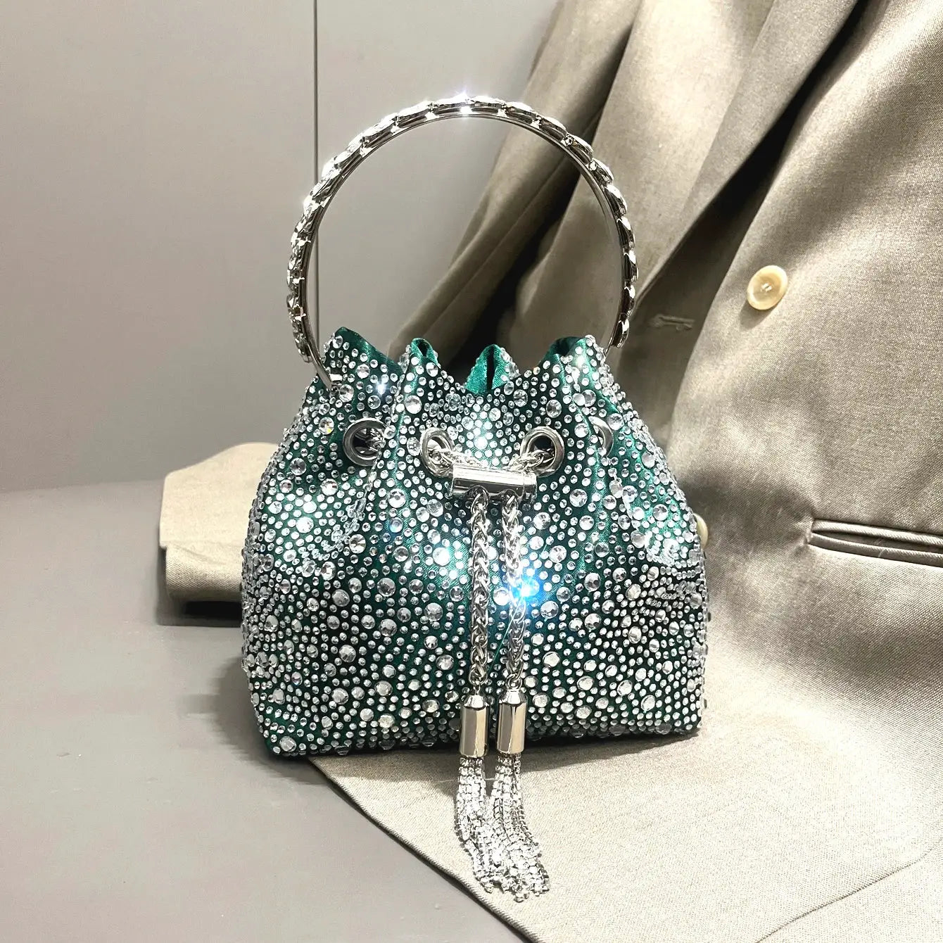 Simples Market teal rhinestone evening clutch with circular jeweled handle and crystal tassels
