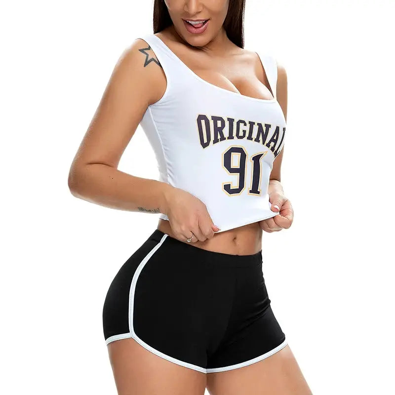 Women's black stretch athletic shorts with white piping, paired with a white sleeveless crop top.