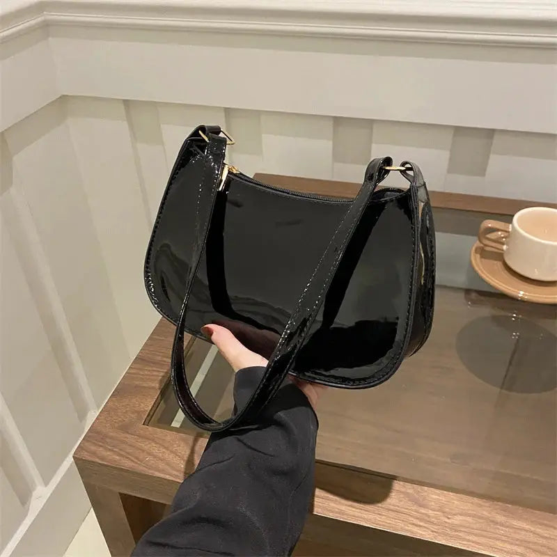 Retro PU leather shoulder bag in black with glossy patent finish and long strap