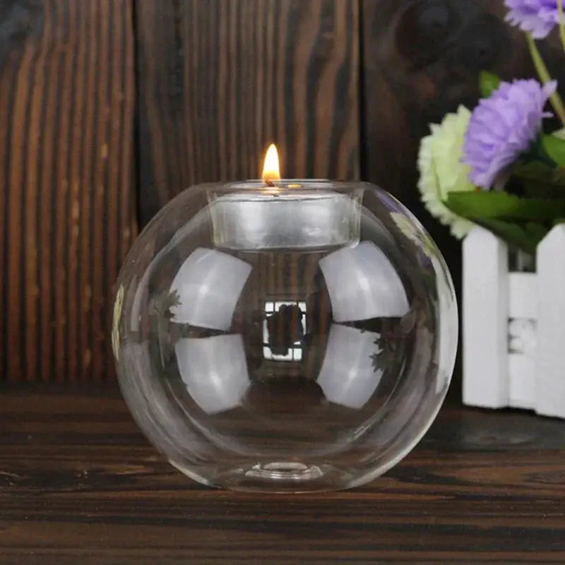 Elegant round glass candle holder, European-style centerpiece with a lit candle on dark wood