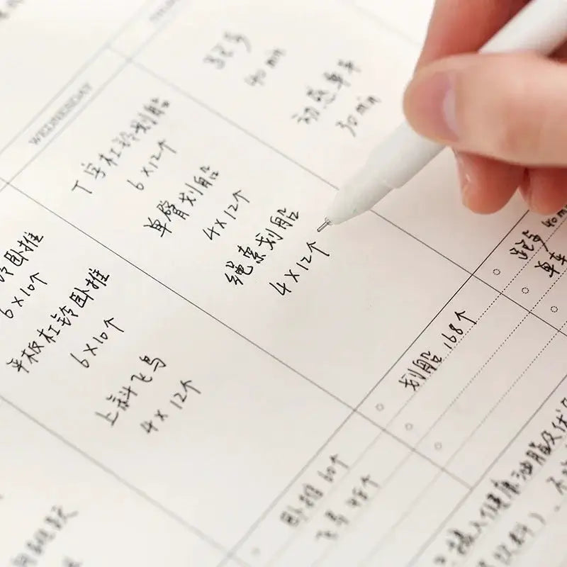 Weekly planner notebook with undated grid layout and white pages