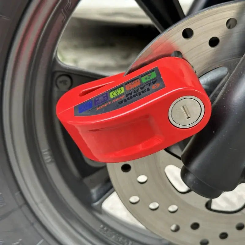 Falante motorcycle alarm disc lock in red with aluminium alloy body attached to brake rotor