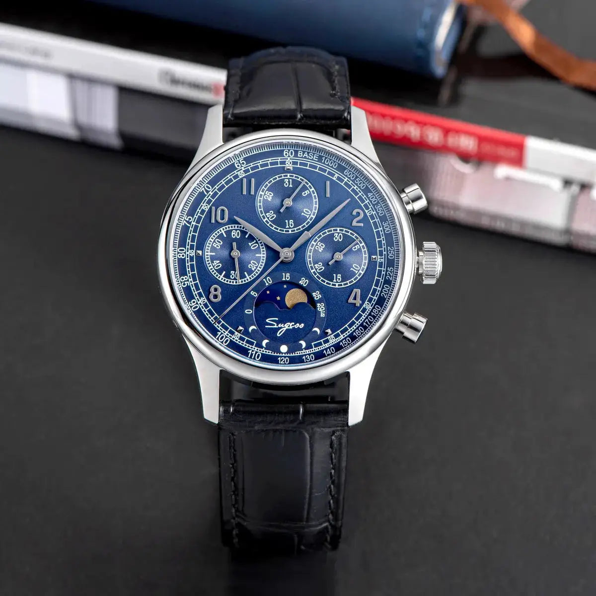 Sugess men's chronograph wristwatch with blue dial, stainless steel case, black leather strap and moonphase indicator