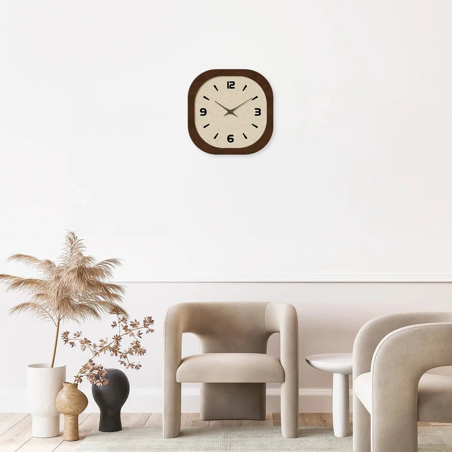 Square wooden wall clock with cream face, dark-brown frame, and bold black numerals on a white wall.