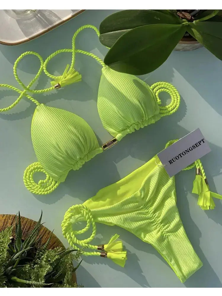 Bikini set in neon lime with backless rope-triangle top and tassel-ended straps.