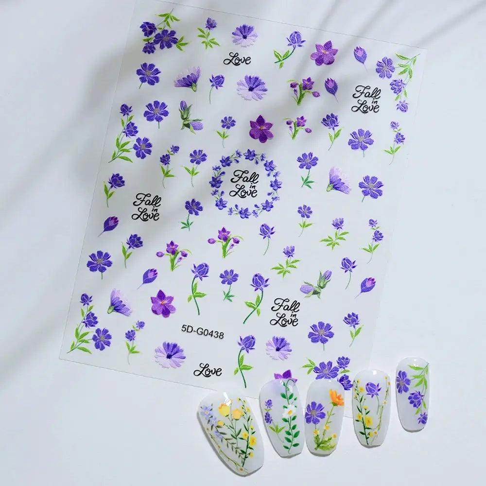 Nail art decal sheet with purple flowers and greenery, featuring Fall in Love script for manicures