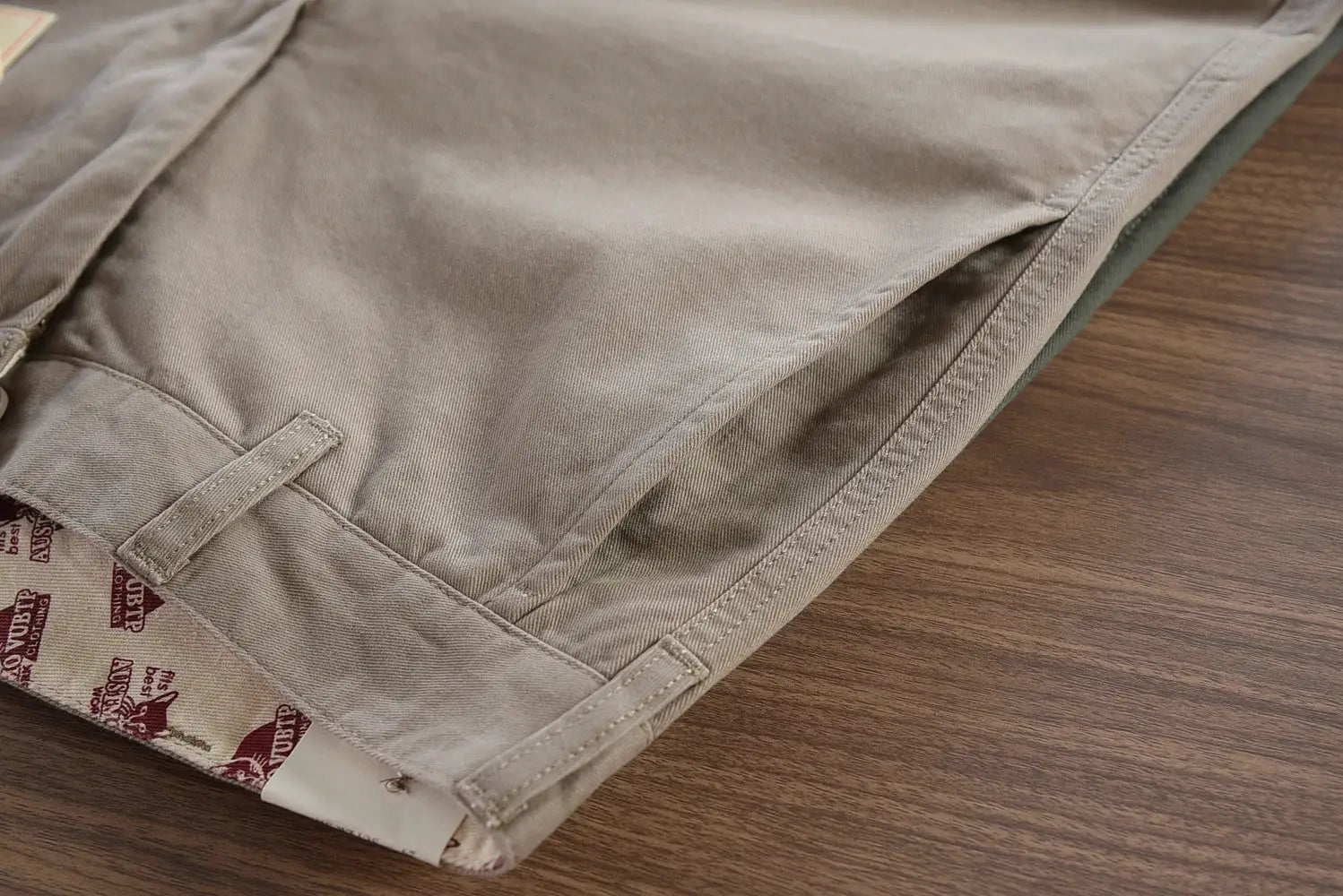 Men's beige cotton twill chinos with belt loops for casual wear.