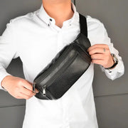 Men's genuine leather chest bag in black with multiple zip pockets, crossbody style.