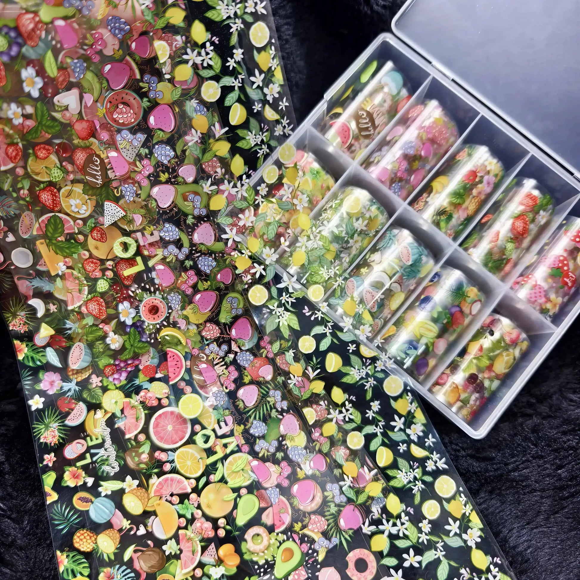 Nail foil sheets: 10 rolls featuring fruit and flower motifs for nail art, in a clear case