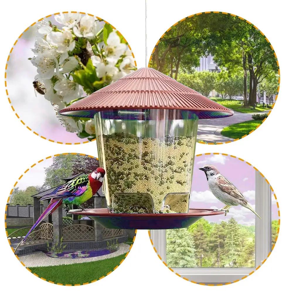 Bird feeder with red roof and clear seed container, hanging outdoor dispenser with multiple feeding holes.