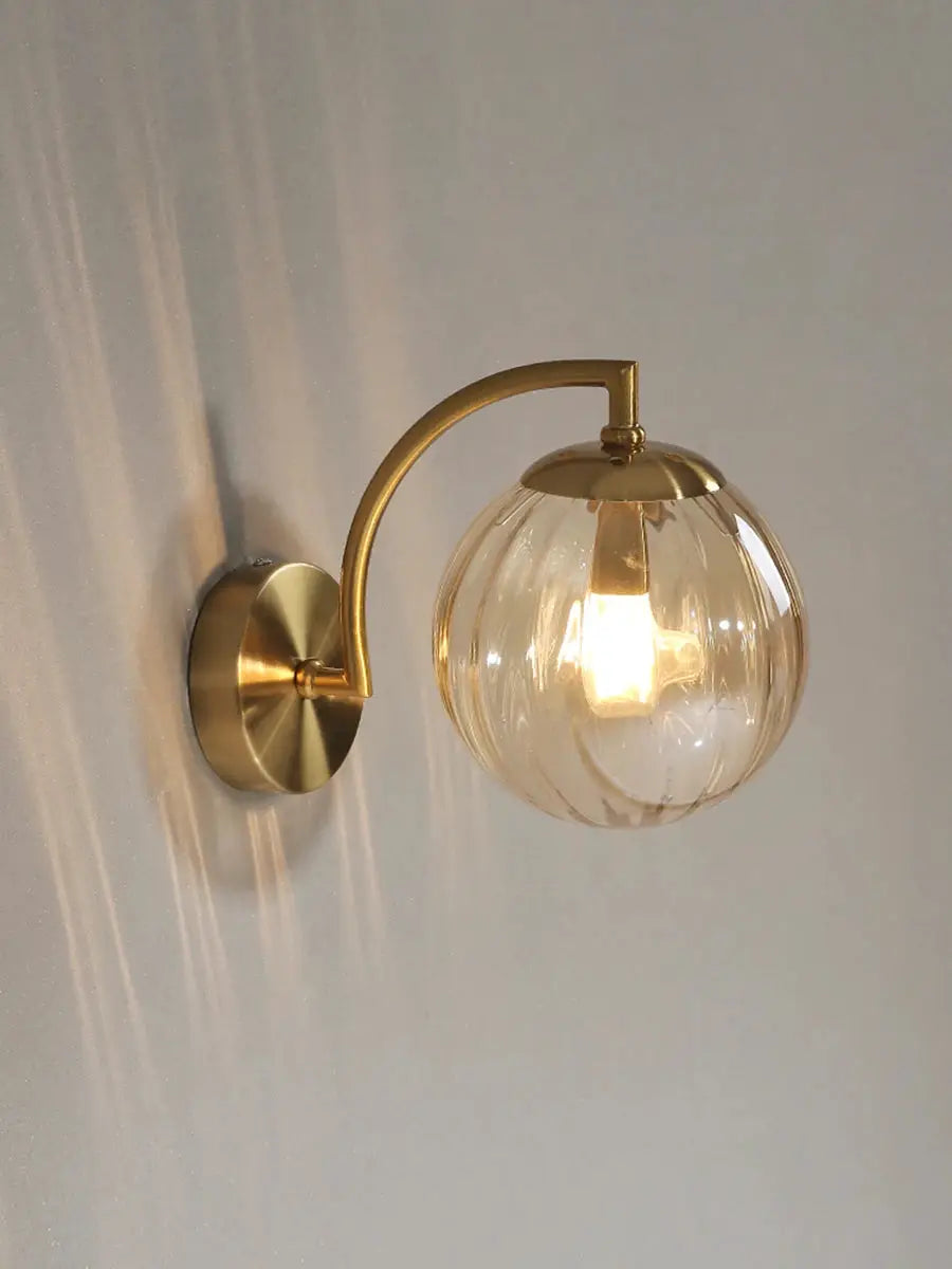LED wall lamp with brass arc and clear glass globe