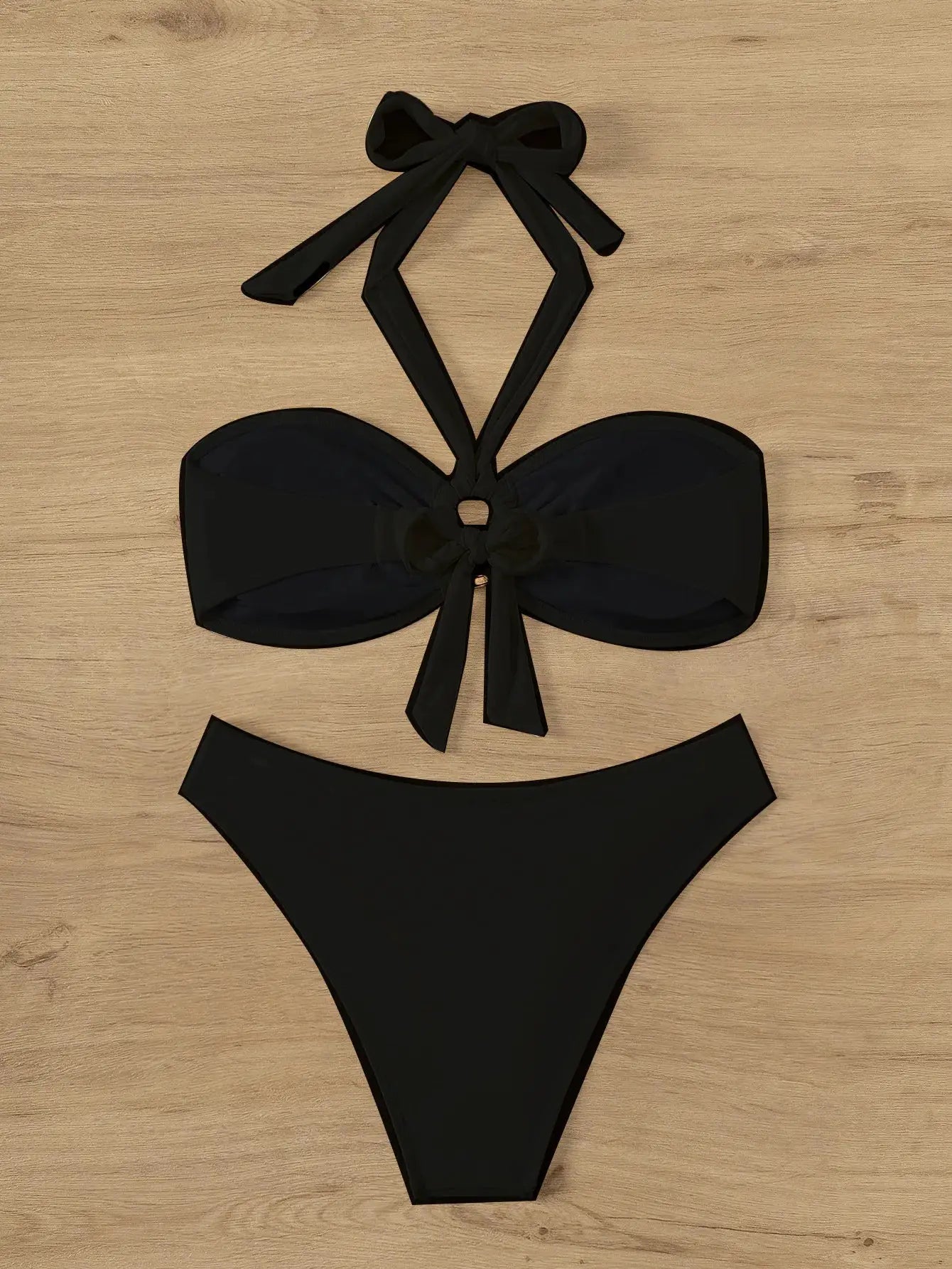 Black bandeau push-up bikini set with neck ties and bow accents; Brazilian thong bottom.