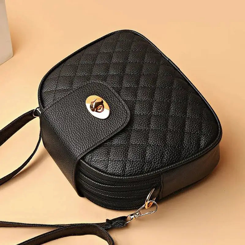 Gentle Compact Quilted Oval Crossbody Bag, black PU with front pocket and multi-zip storage