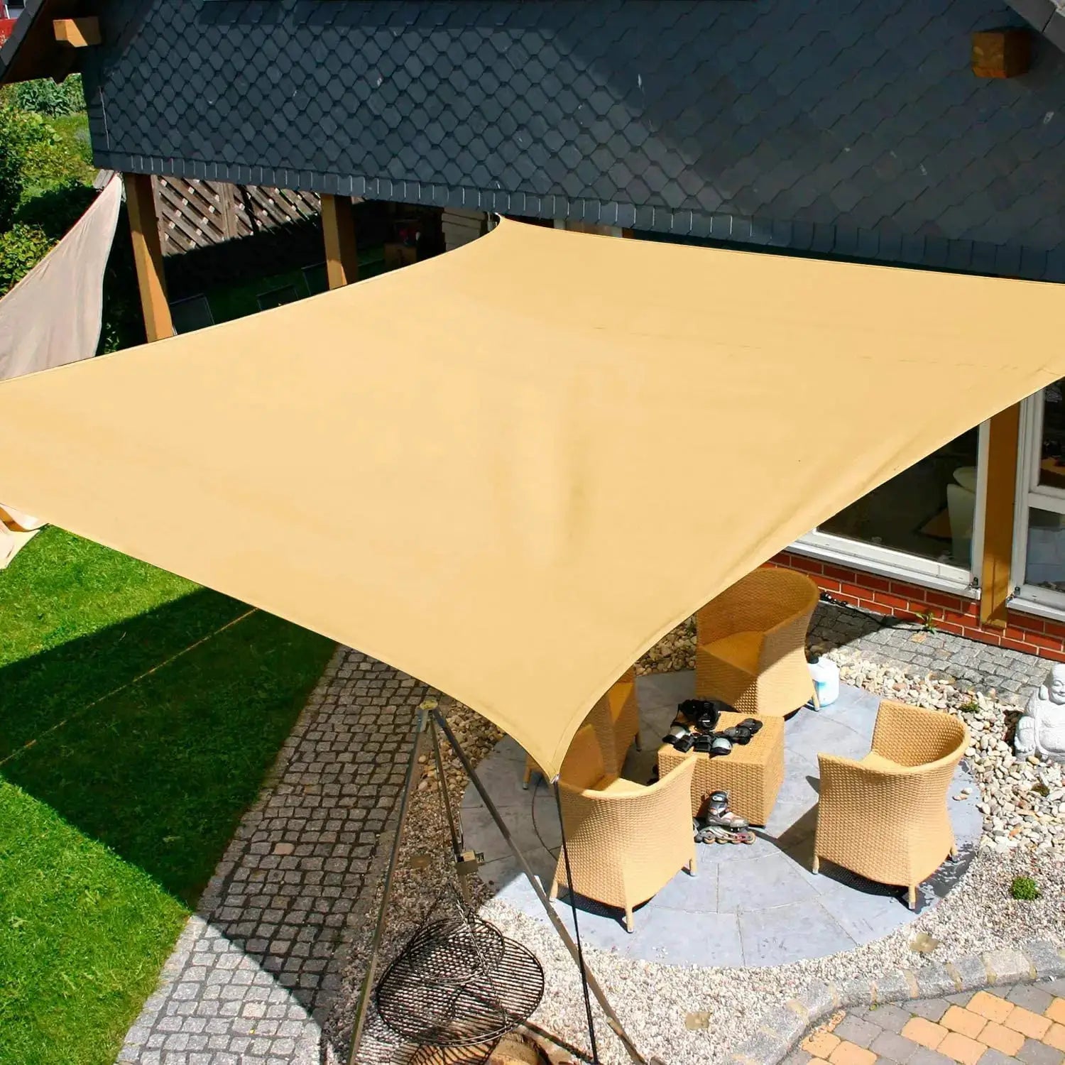 Beige waterproof sun shade sail canopy, rectangular UV-block outdoor shelter over a patio with wicker seating.